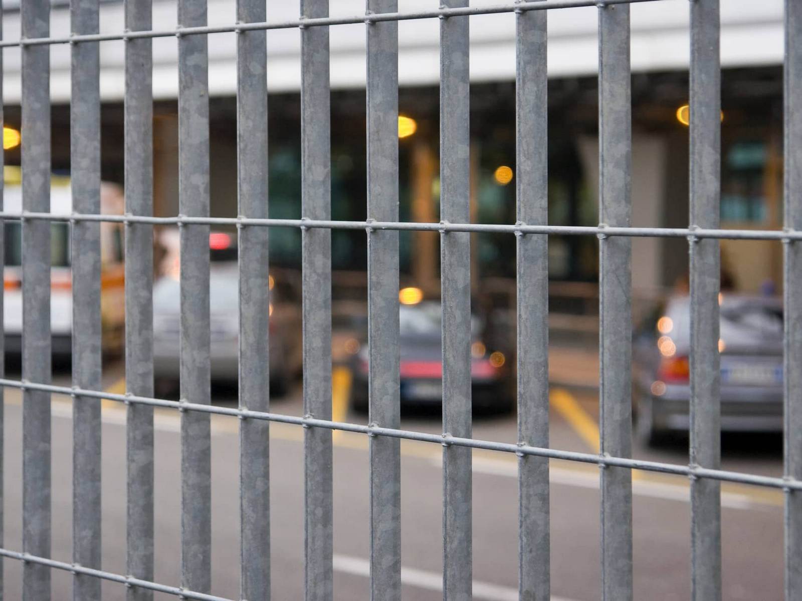 This image shows a close up of an iron security fence on a commercial property.