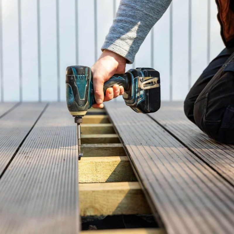 this image shows a contractor installing boards into a new deck